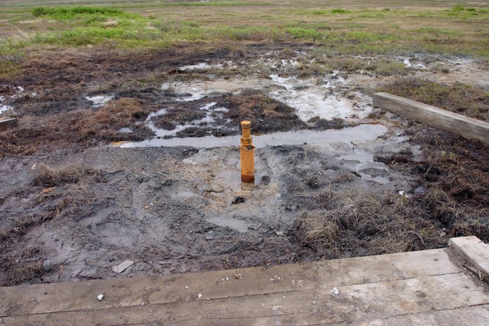 Oily puddles left behind at an old drill rig site, Pebble East. 