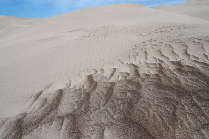 These huge dunes are primarily composed of fairly fine sand, but coarser grains, up to 2 or 3 mm across, are major constituents in certain areas.