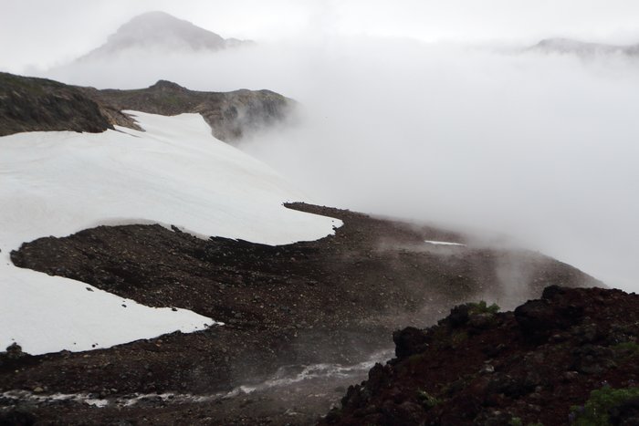 Navigating in the glaciated volcanoes of the aleutian islands is often made more difficult by thick clouds clinging to the slopes.
