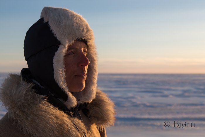 Kim looks out over the frozen Norton Sound as the sun sets.