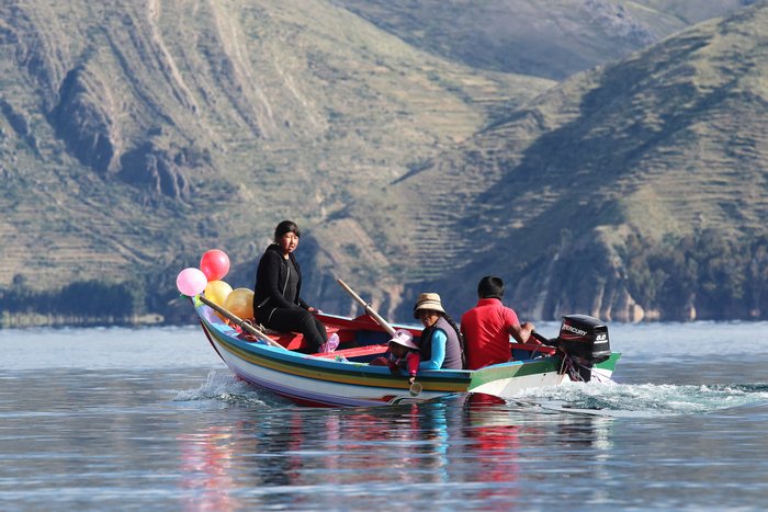 Locals from Isla de la Luna go for a cruise on Lake Titicaca after decorating for Carnaval.