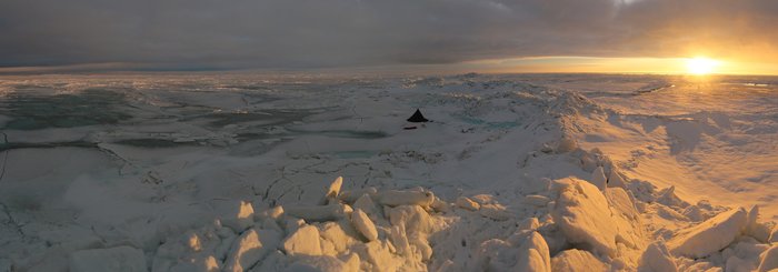 The view from atop a tall stack of ice, as the sun sets on the Chukchi Sea.