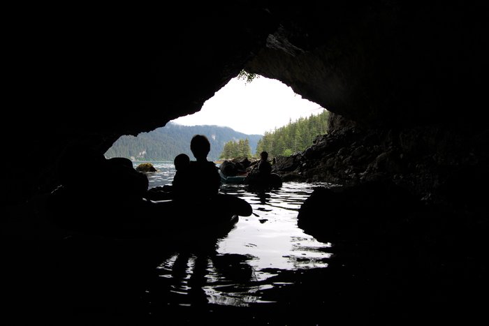Erin and Katmai, along with Katmai's grandma Niki, explore the mouth of a small sea cave on Tutka Bay.