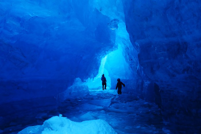 Erin and Lituya explore caves in the front of Grewingk Glacier.
