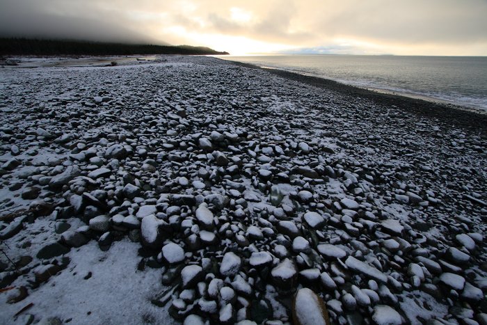 The morning after our harrowing failed attempt at crossing Icy Bay, snow coated the beach.
