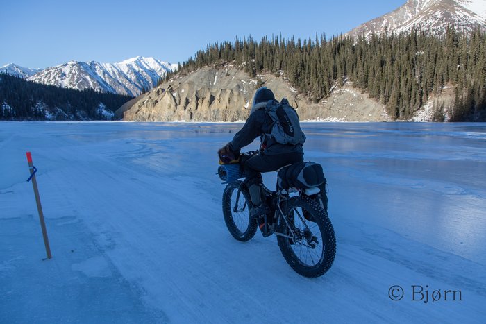 Kim cycles down the headwaters of the Kuskokwim River.