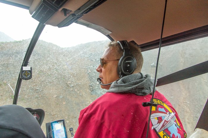 Yakutat Coastal Airlines pilot, Hans Munich, flies above the landslide in Taan Fjord. 