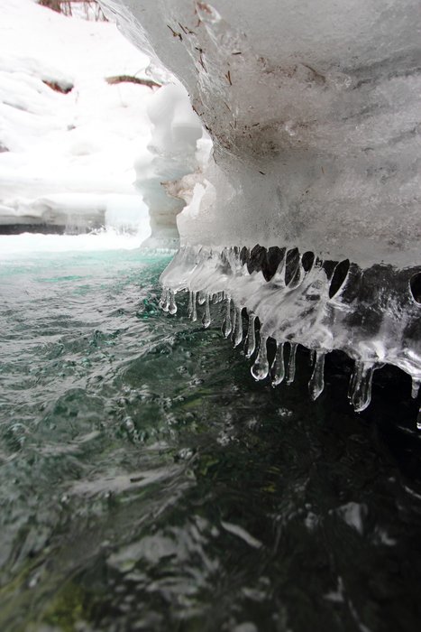Lapping water near a waterfall builds strange ice formations.