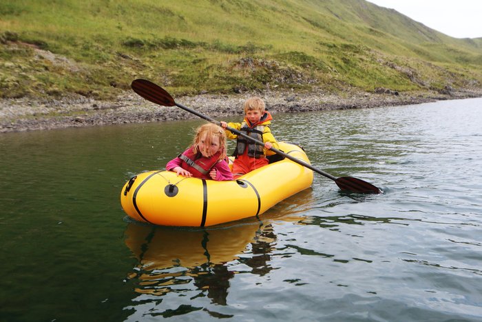 Katmai at age six, paddling his sister across a lake.