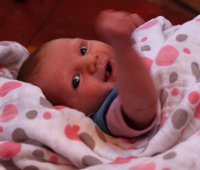 4 weeks old, Lituya gives one of her first smiles along with a fist pump