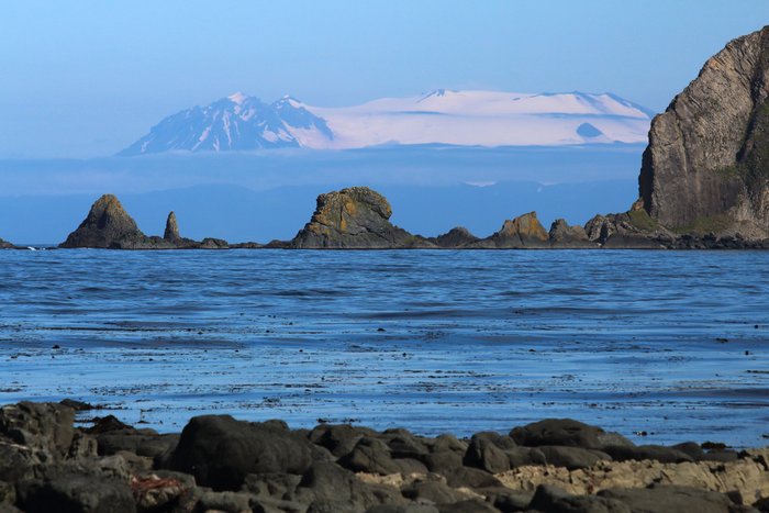 A rare clear day in the Aleutians reveals the broad bulk of Makushin Volcano on Unalaska Island.