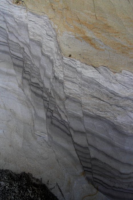 Silty sand, likely nearly fluidized at the time, formed normal faults that accommodated extension.
