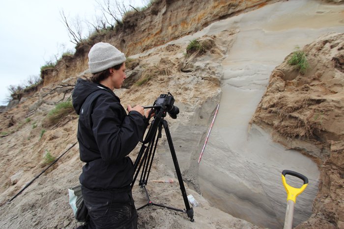 Hanna Craig of <a href="http://mediactionproject.org/">Media Action Project</a> films deformed sedimentary layers - possible evidence of past earthquakes along the coast of Lake Iliamna.