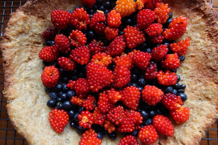fresh salmonberries and blueberry wait for the cooked filling that will glue them into a pie