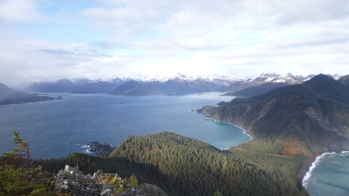 Deep glacial valleys carved between the Kenai Mountains form deep fjords and complex harbors.