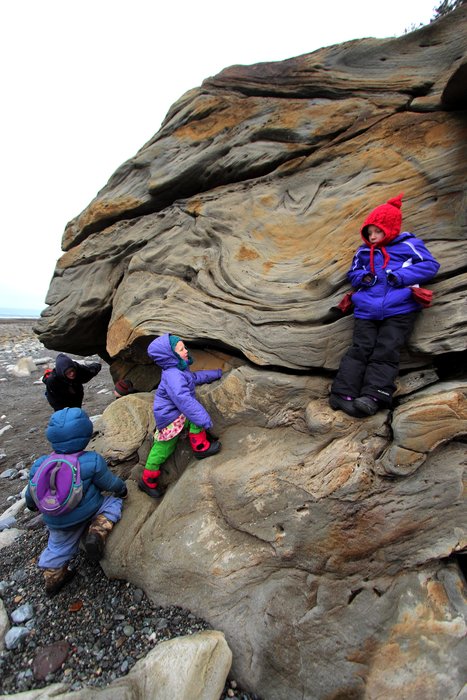 Kids clamber on a large boulder near Barabara Creek.