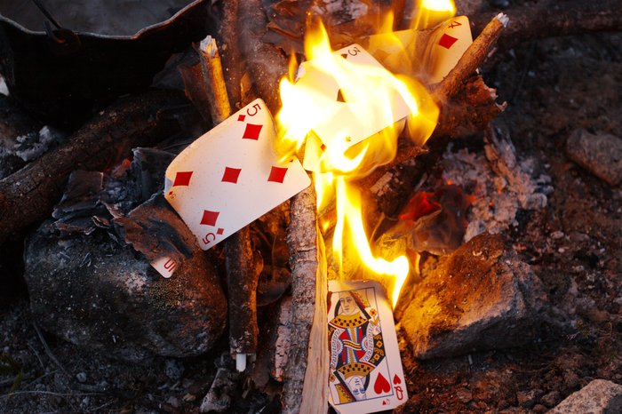 Sue regretted not taking more care to minimize the weight she carried, and decided to burn the deck of cards she'd been carrying for a week without use.