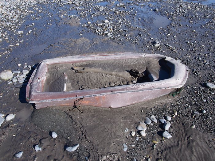 Small boat uncovered by the tides