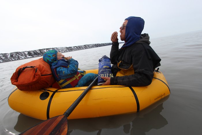 Katmai and Hig eat chips and granola bars while drifting with tidal currents on Cook Inlet.
