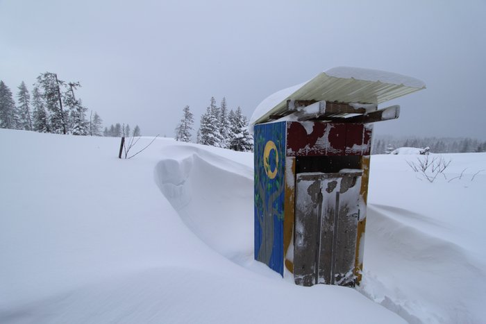 A drift circles around our outhouse.