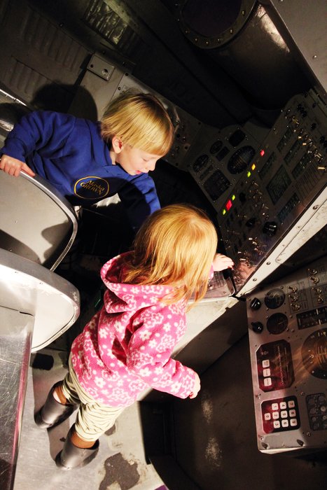 The kids sat in a space capsule at the Seattle Science Center.