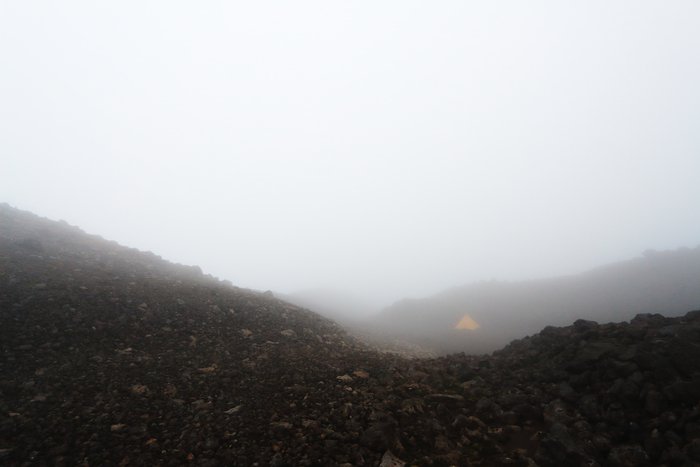We camped high on Pakushin Volcano, and awoke to dense clouds.
