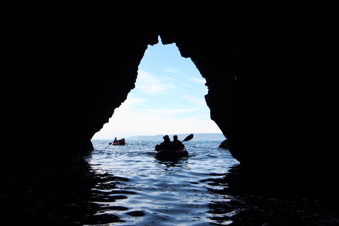Along Kachemak Bay, sea caves and arches are part of the experience.