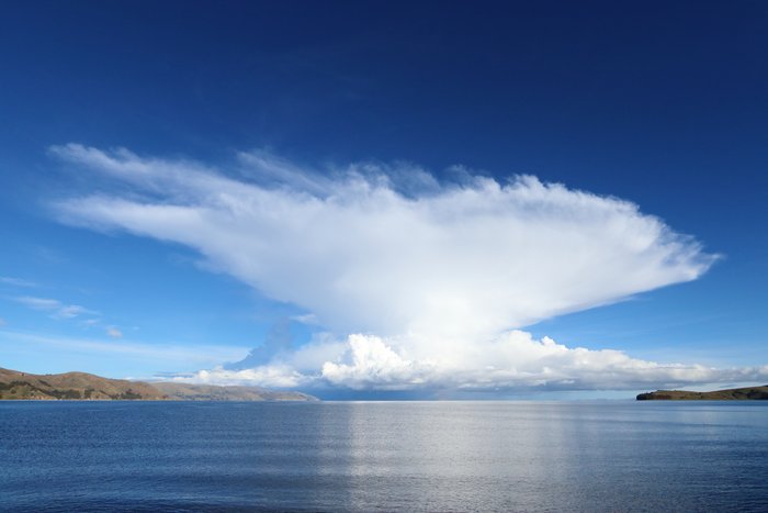 A blue-sky, calm morning provides an excellent view of this isolated storm cell over the lake.