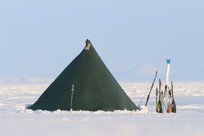 Camped on the sea ice, using our lined tent with wood stove that's served us in many months of harsh weather.