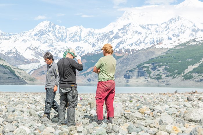Dr. Bretwood Higman and two students discuss where to dig a trench. All of the material in the foreground was deposited from the landslide generated tsunami, nearly five miles away. Much of this area was covered in sediment in excess of several feet. 