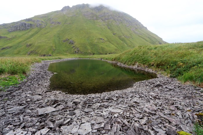 This small lake was probably scoured by a tsunami, which also draped it in shattered bedrock from a nearby hill.