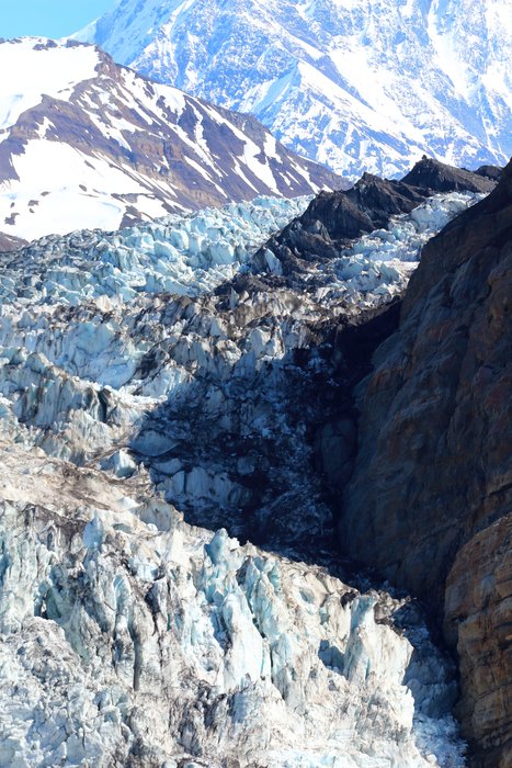 This glacier was once a feeder into the Malaspina Glacier, but it separated from there sometime mid-20th century, and has since retreated until its terminus is a mere 11 miles from the 18000 foot summit of Mt. St. Elias.