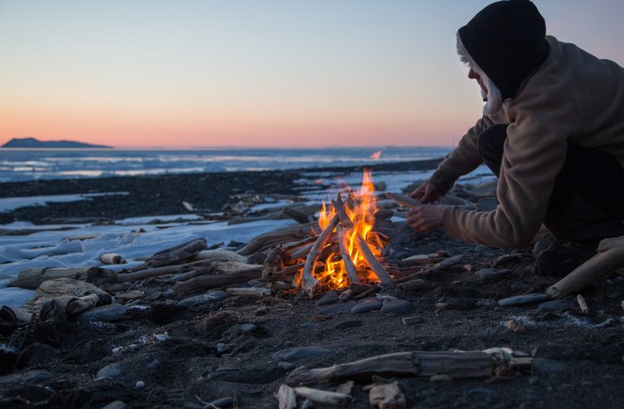 Kim and Bjørn enjoy sleeping out on the Norton Sound coast with a warm fire and beautiful sunset
