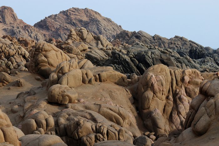 Spheroidal weathering on coarse-grained igneous rocks along Peru's coast.